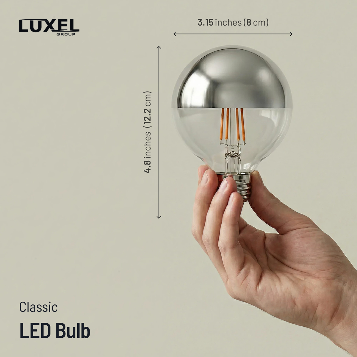 Hand holding a classic LED bulb with dimensions labeled, Luxel brand visible
