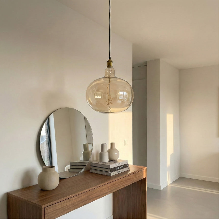 Modern interior with a wooden console table, round mirror, and pendant light.